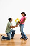 Man giving woman flowers.