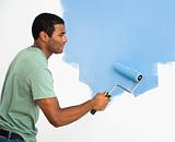 Handsome man painting wall.
