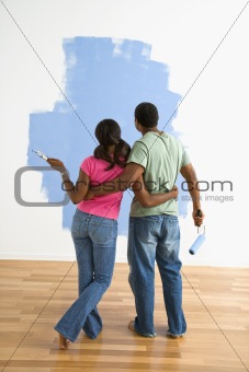Man and woman looking at paint job.