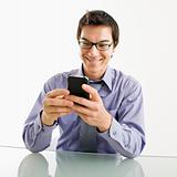 Smiling businessman on cell phone.