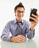 Smiling businessman with cell phone.