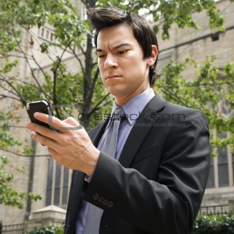 Businessman looking at cell phone.
