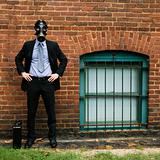 Businessman wearing gas mask.