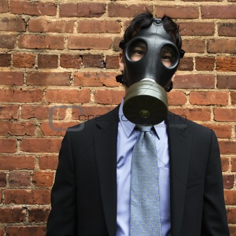 Businessman wearing gas mask.