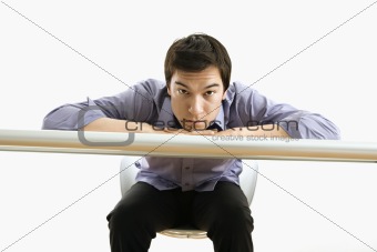 Businessman sitting looking at viewer.