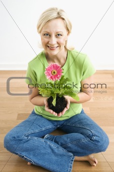 Woman holding gerber daisy.