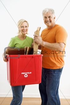 Couple with recycling bin.