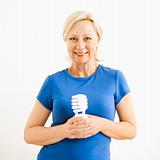 Woman holding lightbulb.