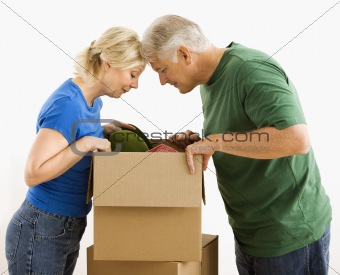 Man and woman looking in box.
