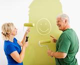 Couple laughing at smiley face painting.