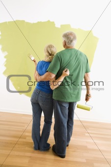 Man and woman observing paint job.