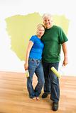 Man and woman with half-painted wall.