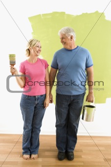 Couple with painting supplies.