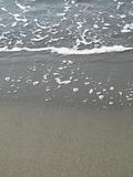 wave crashing on a sandy beach