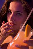 Close-up of young woman drinking and smoking at a bar