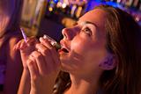 Young woman drinking shots and smoking at a nightclub
