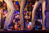 Three young women dancing on a bar counter 