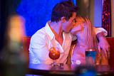 Young couple kissing in a nightclub