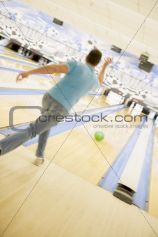 Man bowling, rear view 