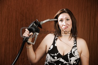 Woman Holding Gas Nozzle to her Head