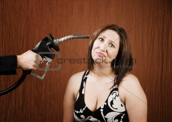 Woman with Gas Nozzle to her Head