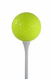 Isolated yellow golf ball on a white tee