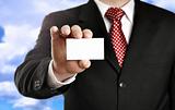 Businessman showing his business card, focus on fingers and card