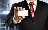 Businessman showing his business card, focus on fingers and card