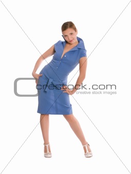 Young woman in blue dress bent playfully with arms on her side.