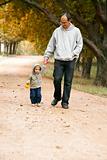 father and son walking in park