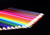 Colorful pencils row isolated on black