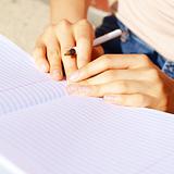 Girl Writing In Note Book