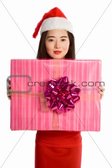 Young Asian woman in Christmas hat with huge gift
