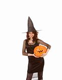 Teenaged girl in Halloween costume with pumpkin(focus on pumpkin
