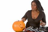 Black make-up artist decorating Halloween pumpkin 
