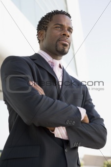 Businessman standing outdoors by building