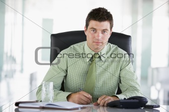 Businessman sitting in office with personal organizer