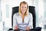 Businesswoman in office with personal organizer smiling