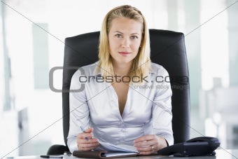 Businesswoman sitting in office with personal organizer