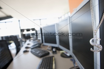 Shot of a necklace hanging on a monitor in a computer room