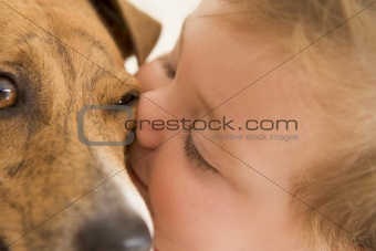 Baby kissing dog
