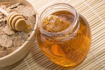 fresh honey with honeycomb and breakfast flakes
