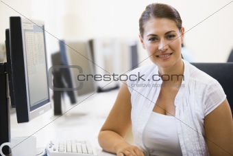 Woman sitting in computer room smiling