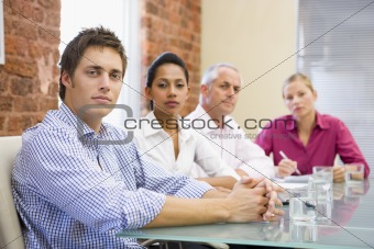 Four businesspeople in boardroom