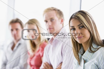 Four businesspeople sitting indoors