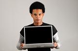 African man holding laptop computer
