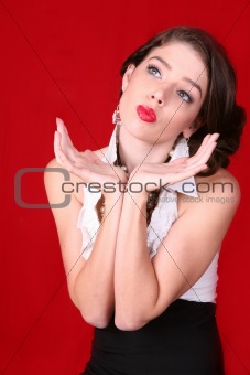 Model Posing With Her Hands on Red Background