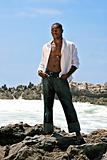 Male African American Model Posing on the Rock on the Beach