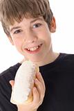 shot of a young boy eating a doughnut