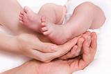 baby foots in hands of parents
